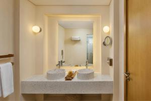 a bathroom with two sinks and a large mirror at Sheraton Miramar Resort El Gouna in Hurghada