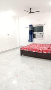 a bedroom with a bed and a microwave in a room at Hotel DEEPAK PALACE in Gaya +9 photos