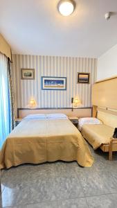 a hotel room with two beds in a room at Hotel Ariella in Milano Marittima