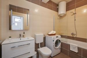 a bathroom with a washing machine and a washer at Cavtat Micika Apartment in Zvekovica +26 photos