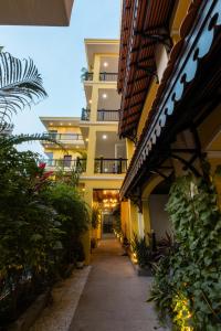a hallway of an apartment building with plants at Sunflower Angkor Boutique Hotel in Siem Reap