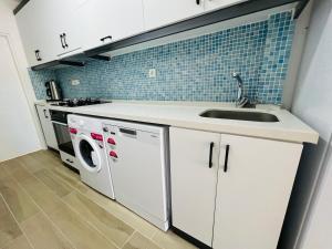 a kitchen with a sink and a washer and dryer at Alara loft in Antalya +5 photos