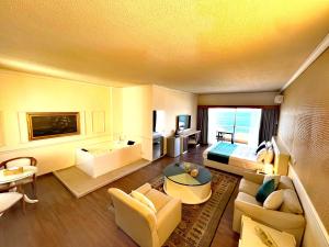 a hotel room with a bed and a living room at Hotel Méditerranée Beyrouth in Beirut