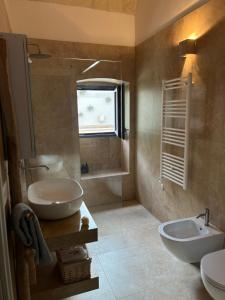 a bathroom with a sink and a toilet and a mirror at Lamia Al Mar in Torre Canne