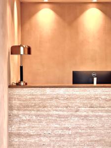 a lobby with a desk with a lamp on it at Armata Boutique Hotel in Spetses