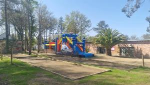 a playground in a park with a slide at Charmant bungalow à Piriac-sur-Mer avec piscine partagée in Piriac-sur-Mer