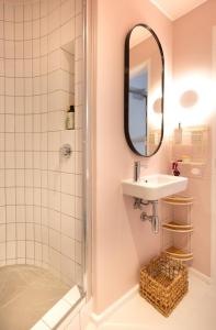 a bathroom with a sink and a shower at Elegant Studio by the Sea in Cape Town +35 photos