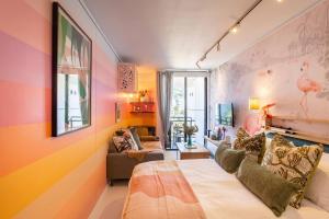 a room with a bed and a couch in it at Elegant Studio by the Sea in Cape Town