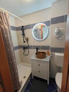 a bathroom with a sink and a shower with a mirror at App Hedonist in Novigrad Istria