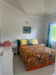 a bedroom with a bed with a colorful blanket at Beautiful Villa on the Sea in Lagun