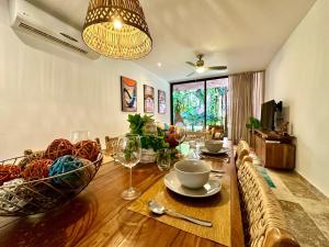 a dining room with a table with plates and wine glasses at Caribbean soul in Tulum