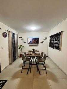 a dining room with a table and chairs and a television at Home Sweet Home at Opico Garden in San Juan Opico