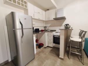 a kitchen with a stainless steel refrigerator and a stove at Minicasa moderna in Castelar