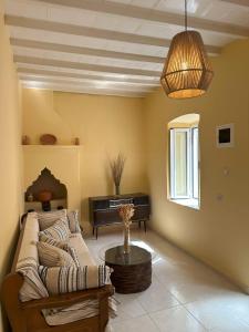 a living room with a couch and a piano at Elia Old Mansion in Malona Village