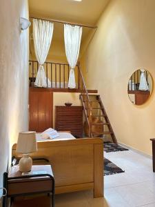 a bedroom with a bed and a staircase with a mirror at Elia Old Mansion in Malona Village +34 photos