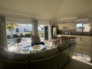a living room with a couch and a kitchen at Beautiful Villa on the Sea in Lagun