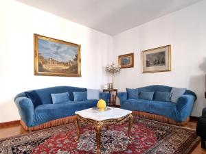 a living room with two blue couches and a table at Mancini 1 - Gran Madre in Turin