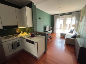 a kitchen and living room with a stove top oven at La dimora del Marchese in Duomo in Milan