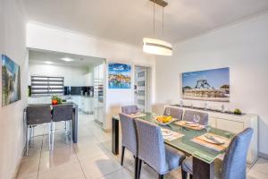 a dining room and kitchen with a table and chairs at La Casa Provenza in St Paul's Bay