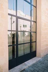 a black door on a building with windows at Il Granile Contemporary Loft in Matera