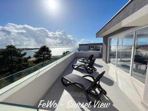 a balcony with a view of the water at VIRCATION Apartments in Vir