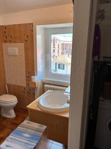 a bathroom with a tub and a toilet and a window at Ester Lakehouse, graziosa casa indipendente in Lierna +35 photos