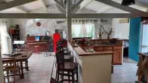 a kitchen with wooden tables and chairs in a room at La Belle Echappée in Champagnac