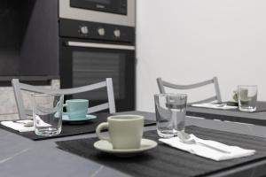 a table with two chairs and a table with glasses at Ka Millordi in Frascineto