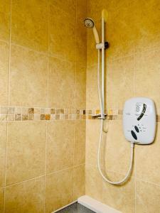 a shower in a bathroom with a shower head at Home like 3 bed house Sheffield in Sheffield