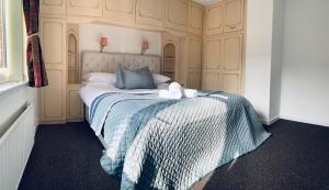 a bedroom with a bed with two stuffed animals on it at Home like 3 bed house Sheffield in Sheffield +12 photos