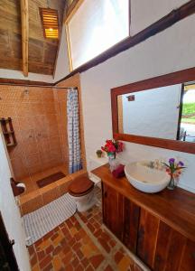 a bathroom with a sink and a toilet and a shower at Cabañas La Tortuga in Ayampe +60 photos