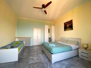 a bedroom with a bed and a ceiling fan at Villa Silvana in Perledo