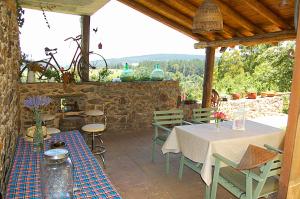 a patio with a table and chairs and a bike at Nuevo sabor rural Ribeira Sacra in A Pobra do Brollon