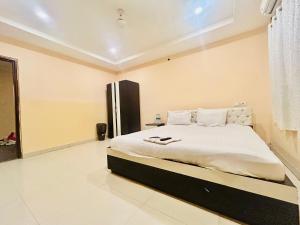 a bedroom with a large bed in a room at Newtown Galaxy Guest House in kolkata