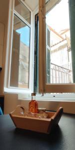 a bottle on a tray in front of a window at Magnolia Urban Apartments, Corfu Town in Ágios Rókkos +58 photos