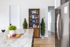 a kitchen with a counter and a refrigerator at Adora in the Pines with Axe Throwing in Flagstaff