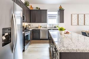 a kitchen with a refrigerator and a counter top at Adora in the Pines with Axe Throwing in Flagstaff +72 photos