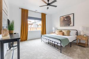 a bedroom with a bed and a ceiling fan at Adora in the Pines with Axe Throwing in Flagstaff