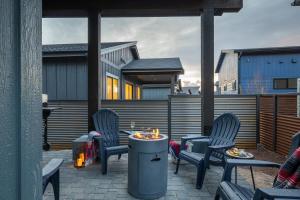 a patio with chairs and a table with a fire pit at Adora in the Pines with Axe Throwing in Flagstaff