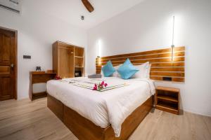 Postel nebo postele na pokoji v ubytování Oasis Dhigurah