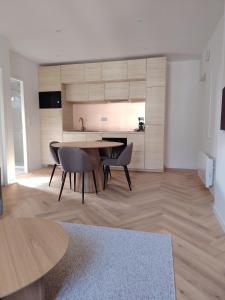 a kitchen and dining room with a table and chairs at Le Gally 40m2 Cœur de ville avec garage! in Rodez +8 photos