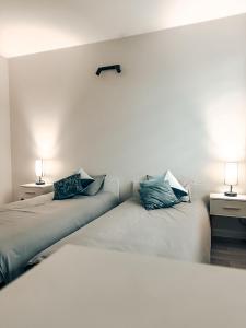 two beds sitting next to each other in a room at Zosieńka in Podolsze +1 photo