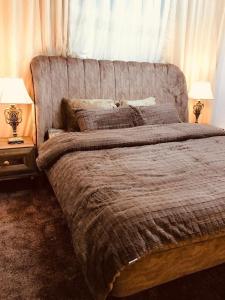 a bedroom with a large bed with two lamps at July house in Wadi Musa