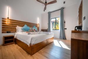 Postel nebo postele na pokoji v ubytování Oasis Dhigurah