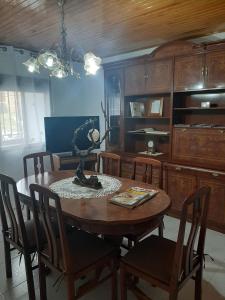 a dining room with a wooden table and chairs at Casa Valeriana Guijosa in Guijosa +21 photos