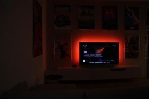a tv in a living room with a red light at Kulturelles Businessapartment in Toplage in Chemnitz +38 photos