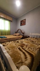 two beds sitting next to each other in a room at Departamento in Termas de Río Hondo