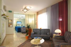 a living room with two couches and a table at Hotel Alexandra in Vinci