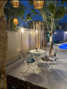 a table and chairs with lights on a patio at וילה בר בוטיק אילת in Eilat