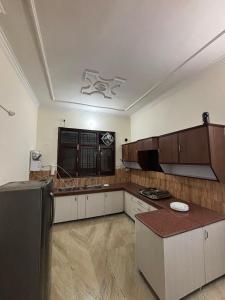 a kitchen with white cabinets and a counter top at Whispers of Peace Villa in Amritsar